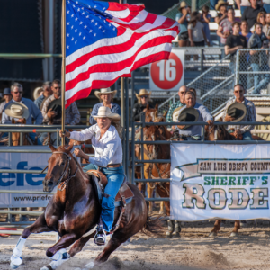 Woman Riding Horse with Flag at Sheriff's Rodeo