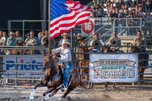 Woman Riding Horse with Flag at Sheriff's Rodeo