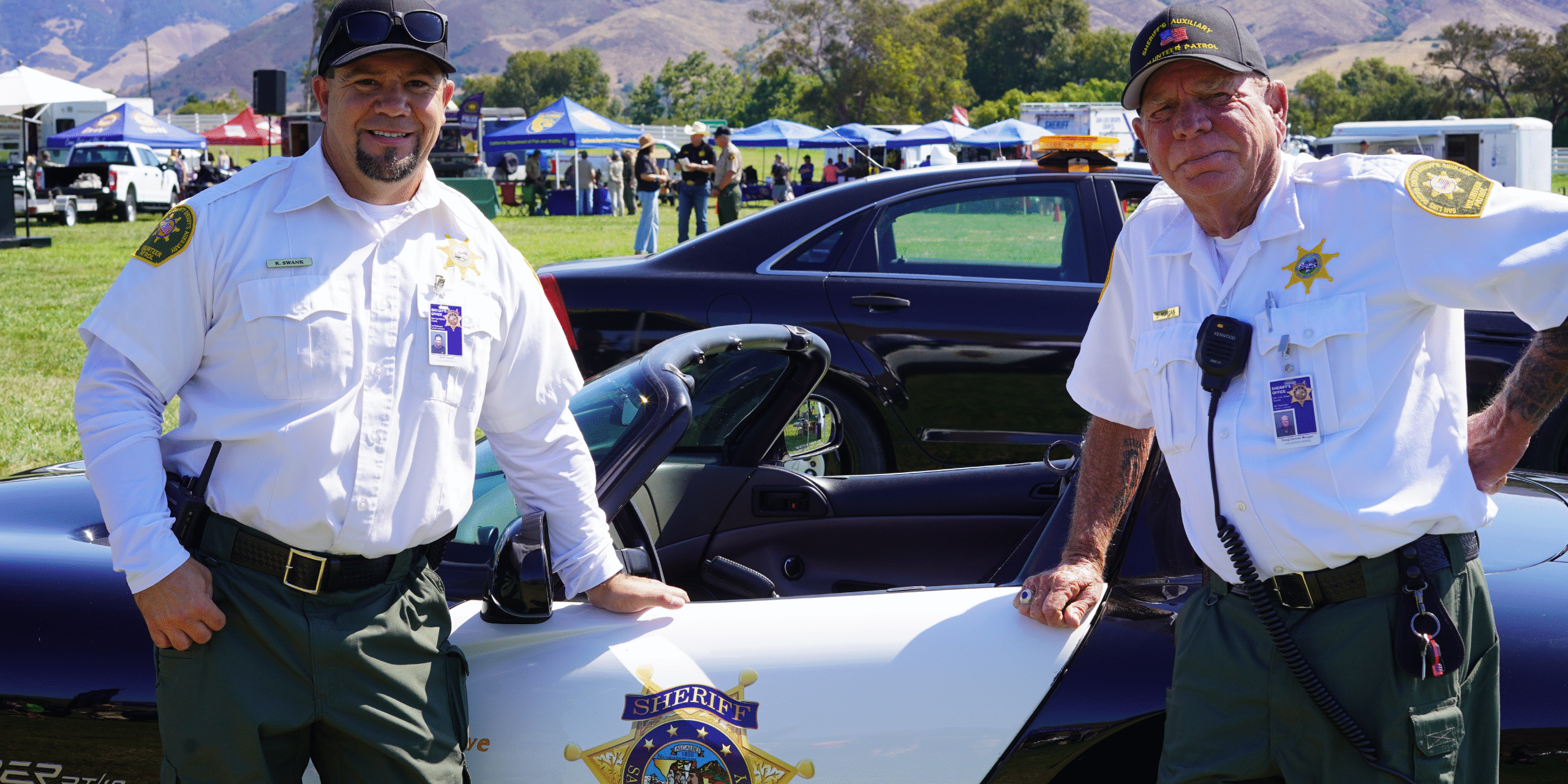 Sheriff’s Auxiliary Volunteer Patrol Members Standing in Front of Car Sheriff’s Auxiliary Volunteer Patrol Members Standing in Front of Car