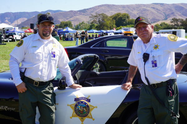 Sheriff’s Auxiliary Volunteer Patrol Members Standing in Front of Car