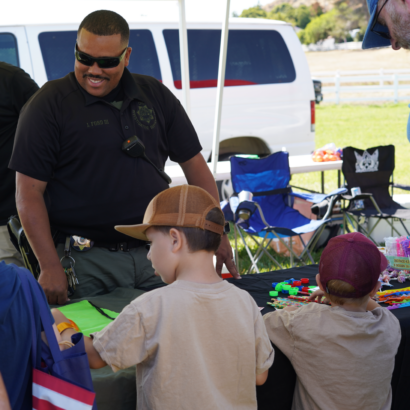 Sheriff Deputy Giving Away Toys to Children