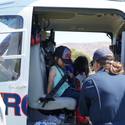 Young Girl Sitting in Helicopter at Family Day Event
