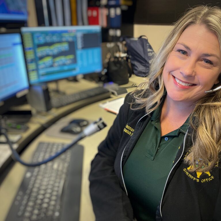 Woman seated at Dispatch Desk for San Luis Obispo County