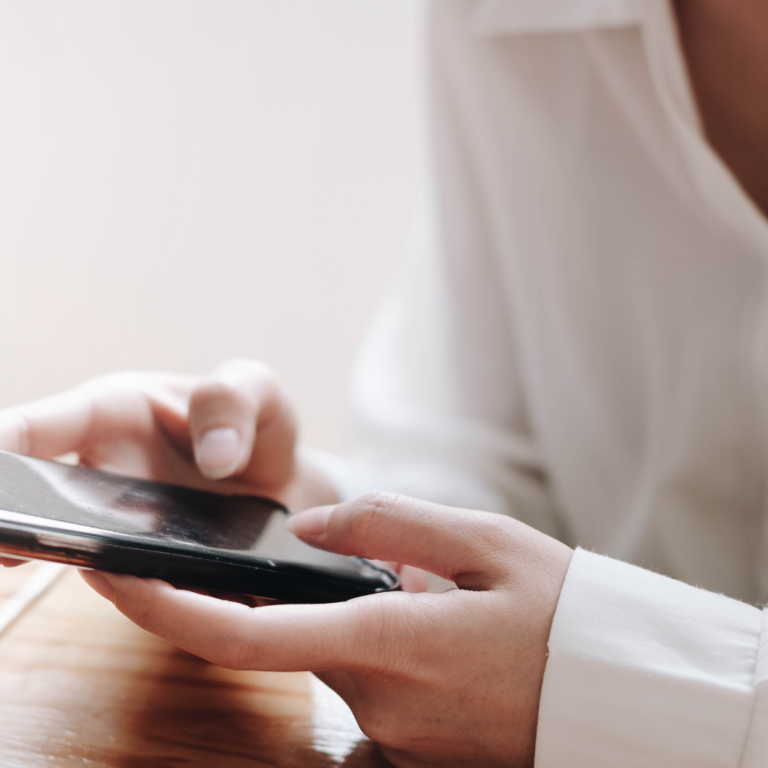 Woman Using Smart Phone to Call in Crime Tip